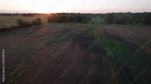 Rural and farmland landscape and background plate of wide shot environment with big grass lawns, trees in woods, open fields, and the sun rising at sun set in New Albany, Ohio