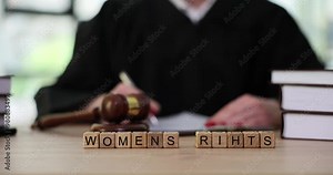 Book about women rights on table of judge in court. Protection of women rights concept