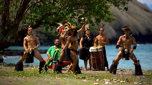Male and female native Marquesan people performing a traditional Bird Dance on the beach wearing traditional clothing Nuku Hiva Marquesas South Pacific