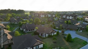 Retirement housing in modern villas and condos. Aerial descending shot at sunset in American suburbia. 55+ community at retirement home. Stock Video