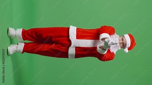 Full Body Of Asian Santa Claus Pointing Finger Gun And Shooting To Camera, Making Choice With Weapon Gesture In Green Screen Studio
