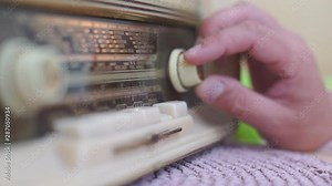 close-up, the ham radio uses the radio tuning knob, tuning the radio wave
