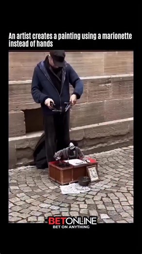 archive on Instagram: "In this video, the artist removes direct contact with the canvas and lets a marionette perform the act of painting. Brushes or ink-soaked sponges are attached to the puppet’s limbs, while all motion is controlled from above using strings and a wooden bar. The artwork emerges from a balance between human intention and the marionette’s physical behavior. Gravity, joint weight, and natural sway shape the strokes in ways that a human hand alone cannot precisely reproduce. The