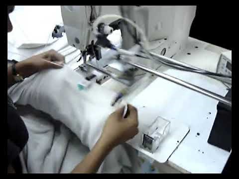 Label attaching machine in garment production.