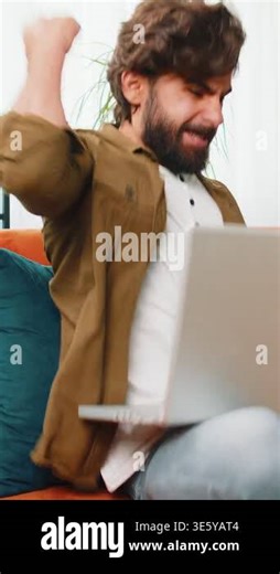 Surprised middle eastern man using laptop computer, receive mail good news message shocked by sudden victory celebrate lottery jackpot win purchases online shopping play game at home apartment on sofa Stock Video Footage - Alamy