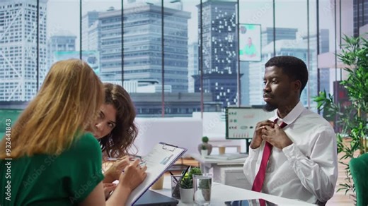 Anxious inexperienced job applicant feeling very uncomfortable during interview, being insecure and overwhelmed while he talks about himself and his qualifications with the HR team. Camera B.