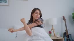 Asian beautiful girl in pajamas wake up in the morning with...