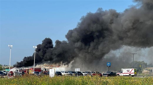 Crews battle massive fire at Chevy car dealership in West