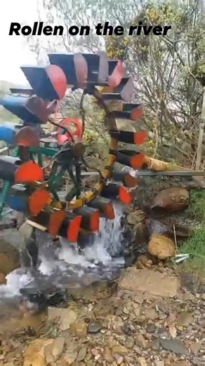 The big OJM waterwheel tipping away, the nice big cast-iron wheel keeps the torque up while simple made buckets fill and turn the whole thing. I have it gears with V belts running through pullys and driving a washing machine motor which is used as a generator hub. I show all build videos on my pages and show what to do with the electricity once it's generated. Like share and follow for more interesting builds from already available scrap parts. #scraptopower #offgrid #renewableenergy #waterwheel