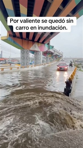 Driver thought he could make it through the puddle but got stuck in the street.