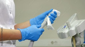 Dental assistant wipes medical devices and tools with disinfectant solution. Processing, Cleaning, sterilization and disinfection of medical dental unit in dentistry, operating medical facility. 4 k