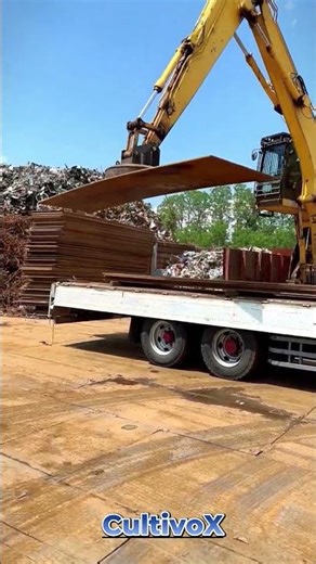Excavator Using Magnetic Attachment to Unload Heavy Steel Plates