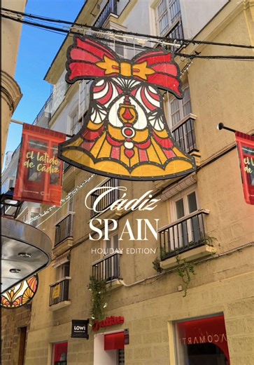 Old Town Cádiz in Spain is festive during the holiday season ✨ We visited at the end of November and the stained-glass-style holiday decorations lined the streets with the soft colors glowing against the whitewashed buildings 🎄 #creatorsearchinsights #cadiz #spaintravel #spaintiktok #christmasdecor
