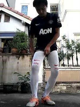 Wearing very long Manchester United socks.