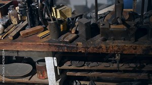 A vintage cobbler shoe making workshop with tools and footwear