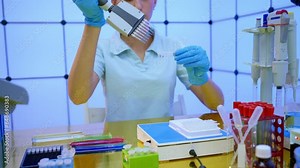 girl laboratory assistant uses an eight-channel multi pipette for genetic analysis Stock Video