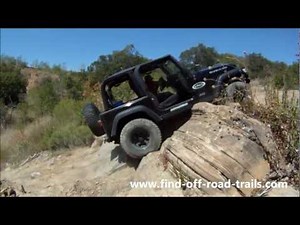 Climbing A Rock Ledge In A Jeep Wrangler Rubicon
