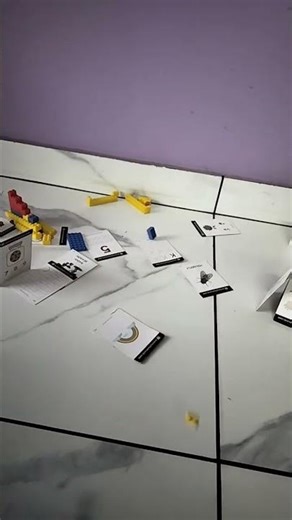 A LEGO plane crashes on a small card house city#lego