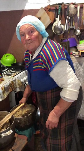 Cooking with Tradition: An Elderly Woman in the Kitchen