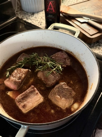 Red wine braised short ribs with no trending audio 😌 Sometimes simple is best. Ingredients 1.5-2 lbs bone in beef short ribs 2/3 cup sliced carrots 1/2 cup sliced celery 2/3 cup diced onion 1 tablespoon tomato paste 1/2 teaspoon Dijon mustard 1 tablespoon olive oil or avocado oil 1 1/2 cups dry red wine 1 1/2 - 2 cups beef stock 2-3 sprigs each Fresh Rosemary and thyme 3 cloves of garlic 1 tsp salt 1 tsp pepper Instructions 1. Preheat your oven to 350°F. Heat a Dutch oven, or any heavy bottom o