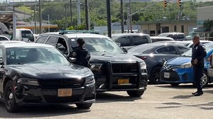 A man on the roof and dozens of Guam police officers swarmed businesses in Harmon. Shops were forced to lock their doors and the scene right across the street from our Harmon studios midday today. Sources close to the investigation say they were searching for suspects wanted in a burglary. Eyewitnesses recalled the fear they felt when armed officers walked into their businesses. | KUAM News