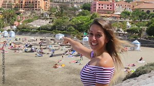 Tenerife. Spain. Beautiful blond girl welcomes you to the beach Playa Del Duque beach, Las Americas. Canary Islands. Girl Travels. .