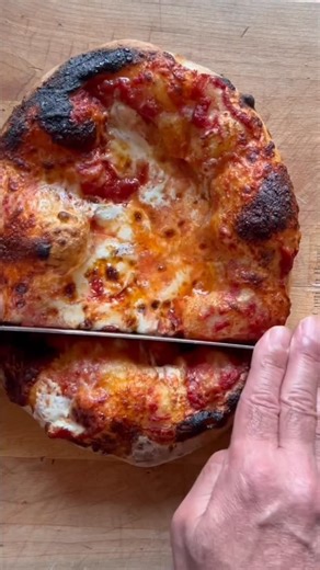 Baking Steel on Instagram: "puffy pizza crust. no scale. no stress. just an overnight dough that turns into clouds. this one is simple: mix a few cups of flour, a cup of water, a pinch of yeast + salt… let time do the heavy lifting. shape it gently, keep all that gas in there, and let the baking steel do its thing at 500° + broil. make it tonight. bake it tomorrow. 🍕⚡️ full recipe puffy pizza (cups & teaspoons) makes 2 small pizzas ingredients • 2 big cups flour (bread or ap) • 1 cup water • 1 