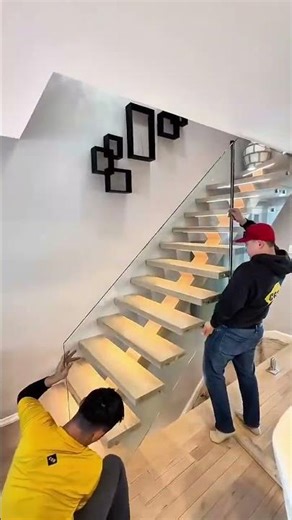 Attaching glass panels to a staircase using hidden support bolts #popular #construction #skills