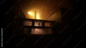 Vidéo Stock Creative artwork decoration. Chernobyl nuclear power plant at night. Layout of abandoned Chernobyl station after nuclear reactor explosion. Man silhouette in window. Selective focus