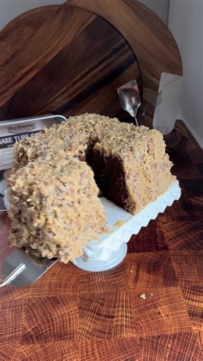 The pan is available at oldcountrykitchenware.com 2 packages (8 ounces) Baker’s German Sweet Chocolate, broken up 1 pound (4 sticks) butter, sliced 1 cup water 4 cups cake flour or White Lily All Purpose Flour 2 teaspoons baking soda 1 teaspoon salt 4 cups sugar 2 cups whole buttermilk 8 large eggs 1 tablespoon vanilla extract Preheat oven to 325°F. Prepare Old Country Kitchenware square tube pan by brushing with chocolate pan coat and lining the bottom with parchment paper (if using two piece p