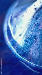 Vertical video. Cone shape. Glossy paint. Defocused blue color sapphire gleam reflected soap liquid drip ink sparkling multifaceted flow motion abstract art background.