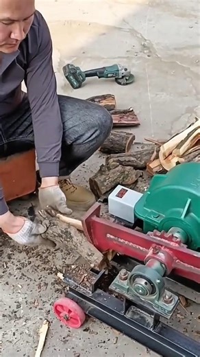 splitting firewood using machine while feeding logs steadily and preparing pieces for use