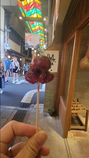 🐙 “Would You Try This? Octopus with Quail Egg at Kyoto’s Nishiki Market!” #NishikiMarket #KyotoEats