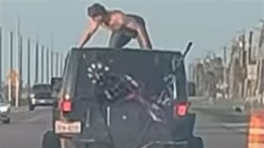 Shock moment half-naked reveller TWERKS on car roof as it speeds down highway