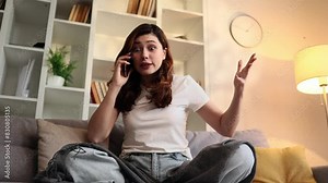 Arguing young woman student or freelancer yelling at laptop by conference video call at home Angry nervous female talk by computer expressing negative emotion indoors Bad conflict conversation