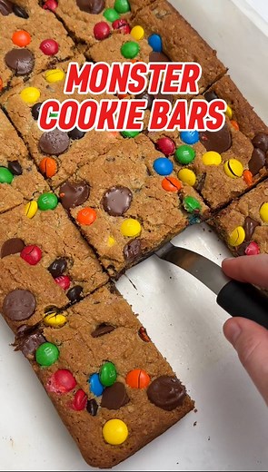 MONSTER COOKIE BARS 🍪 It's ✨ Day 5 ✨ of our 9x13 series and I can't believe the series is almost over! These soft & chewy monster cookie bars are filled with peanut butter, oats, chocolate chips, and of course M&Ms. Perfect to make for any end-of-school year or graduation parties because they're always a hit with crowds, especially kids! Comment "recipe please" and I will DM you the details. #designeatrepeat #bakingpan #monstercookies #monstercookiebars #cookiebars #cookierecipes #cookiesofface