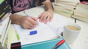 Man studying with a cup of coffee and many books - Free Stock Video