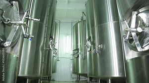 Beer production in the factory. Brewhouse . Malt . Beer is cooled in tanks. Chill . Fresh beer . Natural product. Fridge. Device for cooking