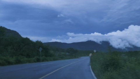 Going down a curved highway through a mountain range - Free Stock Video