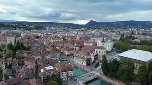 Annecy city center panoramic aerial view over the old town, castle, Thiou river and mountains surrounding the lake. Annecy is known as the Venice of the French Alps