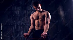 Concentrated shirtless athlete flexing muscles with elastic band Stock Video