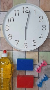 6 o'clock. Cleaning time. Timelapse. Clockwise movement of clock hands after six o'clock. Clock, kitchen cleaning sponge, scrubbing brush, detergent liquid on tiled wall. Weekly Cleaning Plan.