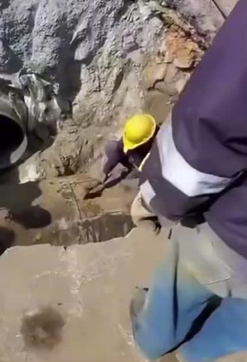 Construction Worker Digging Trench on Site