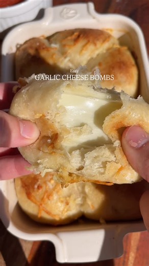 Layla on Instagram: "Garlic Cheese Bombs // recipe 📩 Ingredients: -Trader Joe’s pizza dough or pillsbury biscuits -string cheese or shredded mozzarella -1/3 cup melted unsalted butter -2 cloves minced garlic -salt to taste -Italian herb seasoning -grated Parmesan cheese -parsley (optional) Directions: 1. Preheat the oven to 450 2. In a bowl melt butter and mix in garlic, Parmesan cheese, salt, & Italian spices. 3. If you’re using the pizza dough, cut the dough into 16 pieces. Then roll each pie