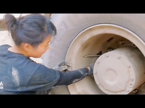 The Strength of Women: Woman Repairing a Truck Chassis