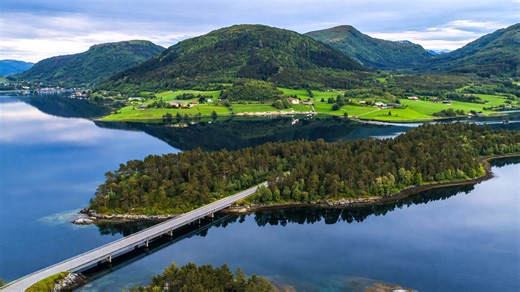 A Nordic fjord with still water and rolling hills
