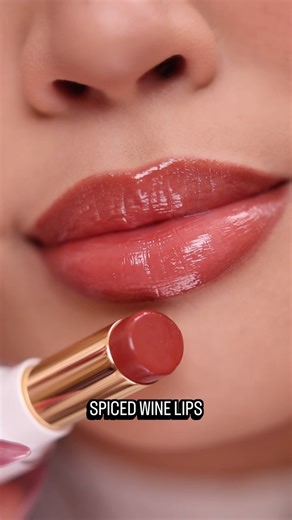 🍂 Meet your new fall essential: Super Lustrous Glass Shine Balm in Spiced Wine Like a cozy sweater for your lips, it wraps them in rich moisture with a glossy finish that glows like golden hour. #Revlon #affordablemakeup #fallmakeup #lipbalm #liptrend | Revlon