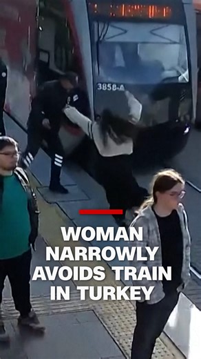 CCTV footage captured the moment a woman wearing earphones narrowly avoided being struck by an oncoming tram. | CNN