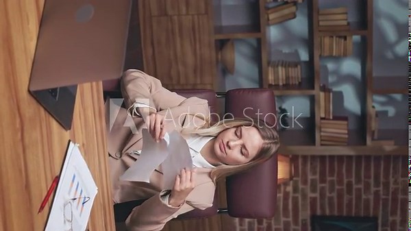 Furious lady having stress and troubles with bad reports at work. Caucasian female feeling pissed off and ripping financial documents while sitting at table with personal computer. Vertical video.