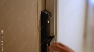 Hand using fingerprint scan for smart digital door lock while open or close the door at home or apartment. NFC Technology, keycard, PIN number, smartphone and contactless lifestyle concepts